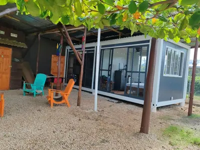 a small house with chairs and a table in front of it at Villa Manzú Santa Cruz, Guanacaste in Santa Cruz