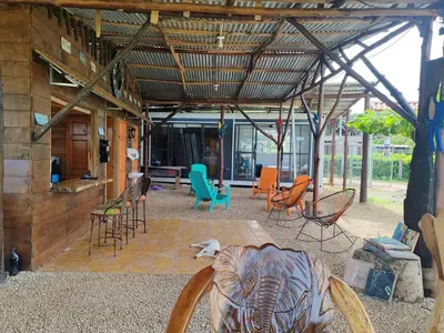 a covered patio with chairs and tables and chairs at Villa Manzú Santa Cruz, Guanacaste in Santa Cruz