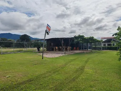 a flag on a pole in a yard with a building at Villa Manzú Santa Cruz, Guanacaste in Santa Cruz