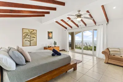 a bedroom with a large bed and a balcony at MPH Spacious Penthouse with Ocean Views in Tamarindo