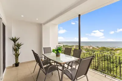 a table and chairs on a balcony with a view of the ocean at MPH Spacious Penthouse with Ocean Views in Tamarindo