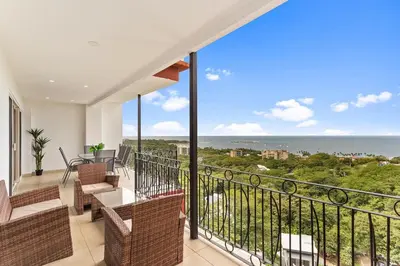 a balcony with chairs and a view of the ocean at MPH Spacious Penthouse with Ocean Views in Tamarindo