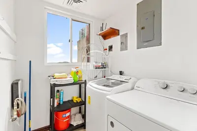 a white laundry room with a sink and a washing machine at MPH Spacious Penthouse with Ocean Views in Tamarindo