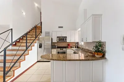 a kitchen with white cabinets and a counter top at MPH Spacious Penthouse with Ocean Views in Tamarindo