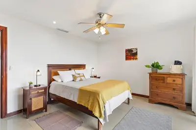 a bedroom with a bed and a ceiling fan at MPH Spacious Penthouse with Ocean Views in Tamarindo