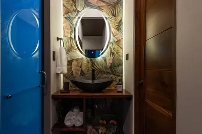 a bathroom with a sink and a mirror at Río Sarapiquí Lodge in Sarapiquí