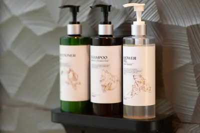 three bottles of soap sitting on a shelf at Río Sarapiquí Lodge in Sarapiquí