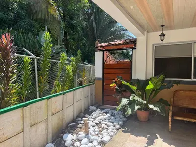 a patio with a fence and a bench and plants at Alma y Paz Beach House in Bejuco