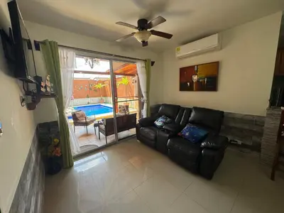 a living room with a couch and a ceiling fan at Alma y Paz Beach House in Bejuco