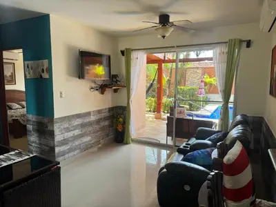 a living room with a couch and a fireplace at Alma y Paz Beach House in Bejuco