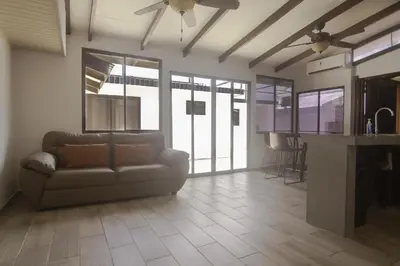 a living room with a couch and a kitchen at JS -14B home in Jacó