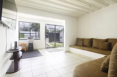 a living room with a couch and a table at JS -14B home in Jacó