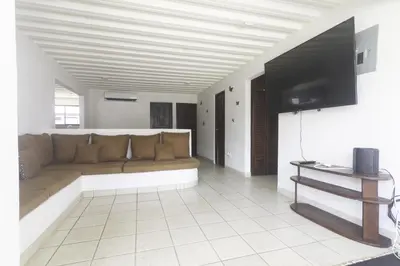 a living room with a couch and a flat screen tv at JS -14B home in Jacó