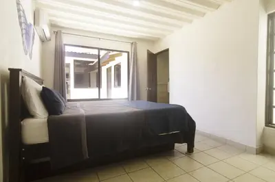 a bedroom with a large bed with a window at JS -14B home in Jacó