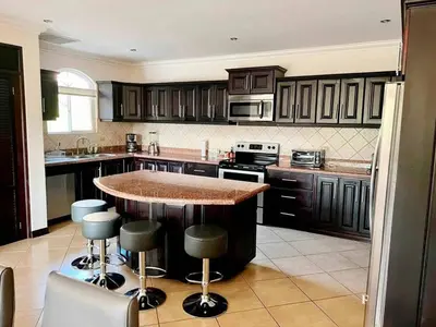 a kitchen with a island in the middle of a kitchen at Pacific Sun Penthouse in Herradura