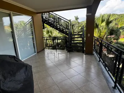 a balcony with a staircase in a house at Pacific Sun Penthouse in Herradura