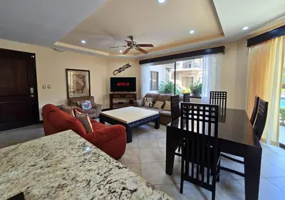 a living room with a couch and a table at Monaco Condominiums Unit 3, Poolside 3BR, Walk to Beach in Jacó