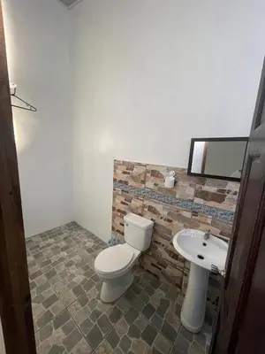 a bathroom with a toilet and a sink at Casa Los Delfines in Tortuguero