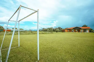 a couple of metal poles in a field with a house at Casa vacacional cerca de la Fortuna San Carlos in Tanque
