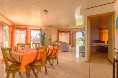 a dining room with a table and chairs at Casa vacacional cerca de la Fortuna San Carlos in Tanque