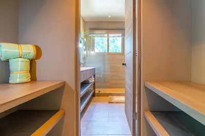 a walk in closet with wooden shelves and a door at Chalet Tropical - by Pura Villas in Ballena