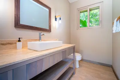 a bathroom with a sink and a toilet at Chalet Tropical - by Pura Villas in Ballena