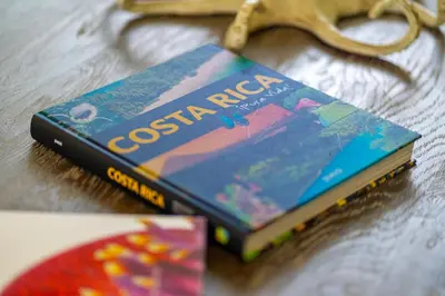two books sitting on top of a table at Chalet Tropical - by Pura Villas in Ballena