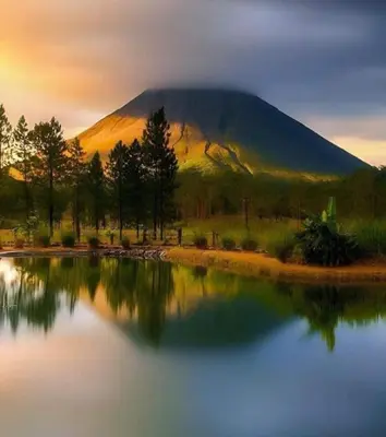 a mountain in the distance with a reflection in a lake at La Cueva del Perezoso in Ángeles