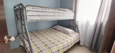a bunk bed in a room next to a window at Bella vista Ceci B1 in San Ramón