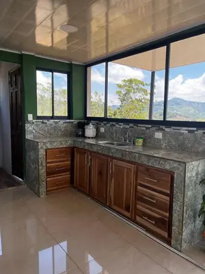 a kitchen with a large sink and windows at Bella vista Ceci B1 in San Ramón