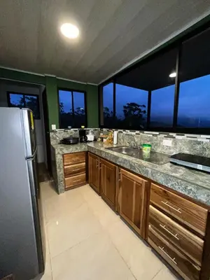 a kitchen with a sink and a refrigerator at Bella vista Ceci B1 in San Ramón