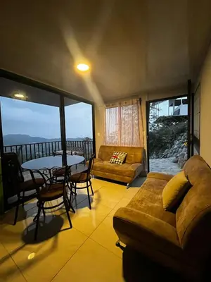 a living room with a couch and a table at Bella vista Ceci B1 in San Ramón