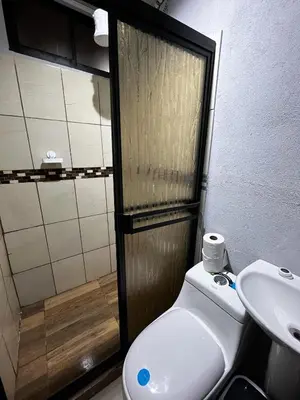 a bathroom with a toilet and a sink and a shower at Bella vista Ceci B1 in San Ramón