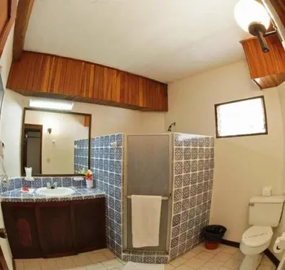 a bathroom with a sink and a toilet at Beach Break Resort & CR Surf Camp in Jacó