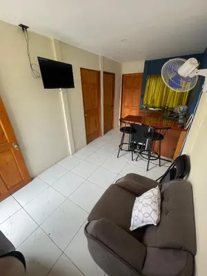 a living room with a couch and a table at Apartamento Nuevo amueblado La Paz #1 Quepos in Savegre