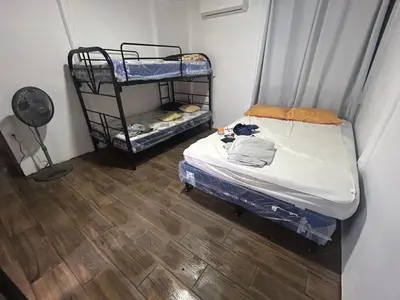a room with two bunk beds and a fan at Casa playa vacaciones in Santa Cruz
