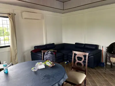 a living room with a blue couch and a table at Casa playa vacaciones in Santa Cruz