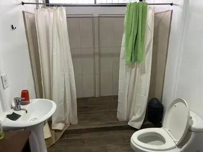 a bathroom with a shower and a toilet and a sink at Casa playa vacaciones in Santa Cruz