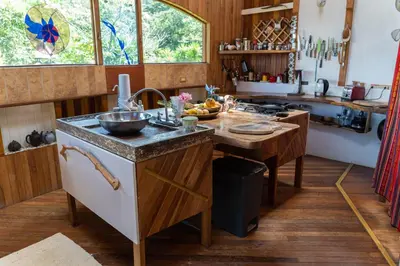 a kitchen with a island with a counter top at Artistic house in a coffee plantation in Tajo Alto
