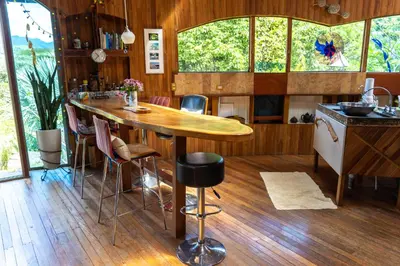 a kitchen with a large wooden table and chairs at Artistic house in a coffee plantation in Tajo Alto
