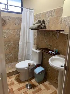 a bathroom with a toilet and a sink at Hospedaje Oropendola Nest in Bagaces