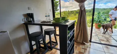 a kitchen with a bar with a dog standing on the patio at Rios-lodge in Mirador