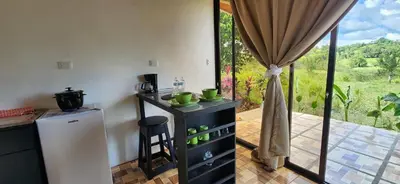 a kitchen with a counter with a refrigerator and a window at Rios-lodge in Mirador