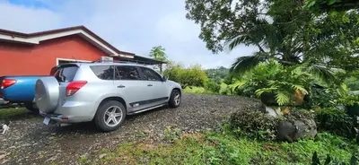 a white car parked in front of a house at Rios-lodge in Mirador