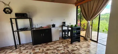 a kitchen with a refrigerator and a sink in a room at Rios-lodge in Mirador