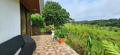 a porch with a bench and plants in a field at Rios-lodge in Mirador