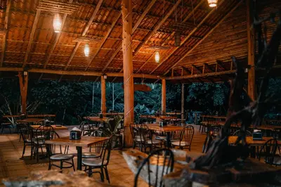 an empty restaurant with wooden tables and chairs at Hotel del Bosque in Río Cuarto