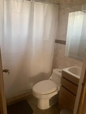 a white bathroom with a toilet and a sink at Casas Vacacionales Tambor Beach in Puntarenas