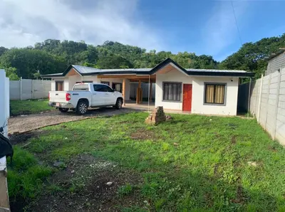 a white truck parked in front of a house at Casas Vacacionales Tambor Beach in Puntarenas
