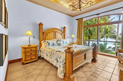 a bedroom with a bed and a large window at Ocean Front Palacio Tropical in Puntarenas